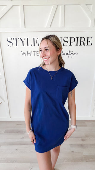 Woman wearing a navy colored t-shirt dress.