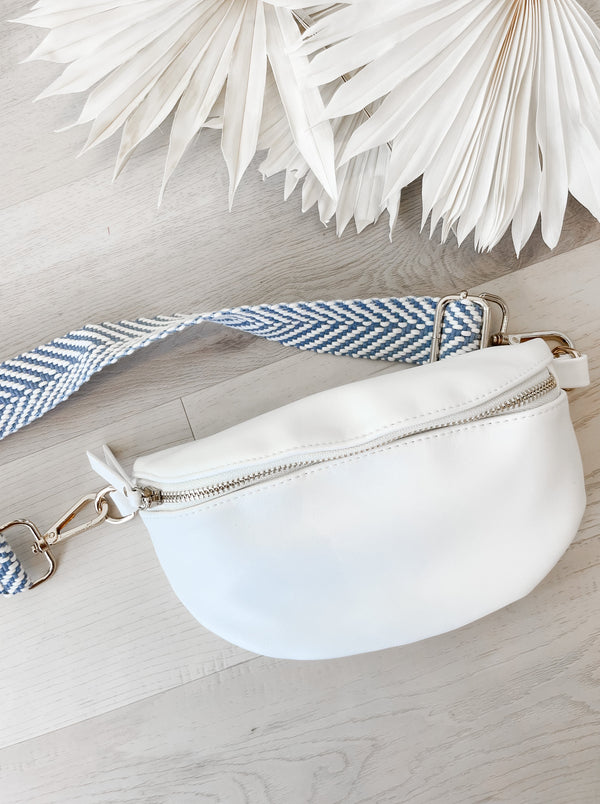 white crossbody/belt bag with a front zipper