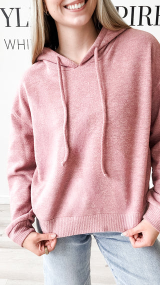Person wearing a pink hoodie 
