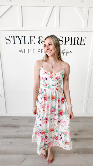 Woman wearing a floral dress with a quilted bodice 