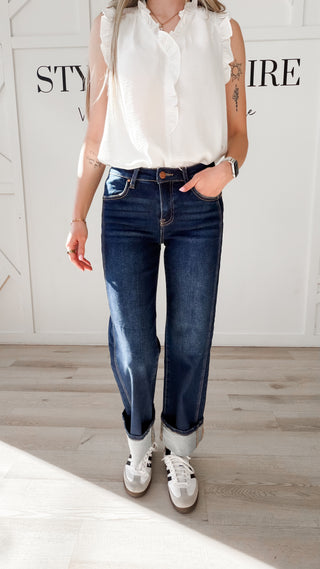 Woman wearing cuffed straight cut dark indigo jeans