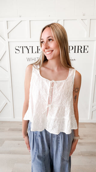 Woman wearing a front tie ruffle floral top