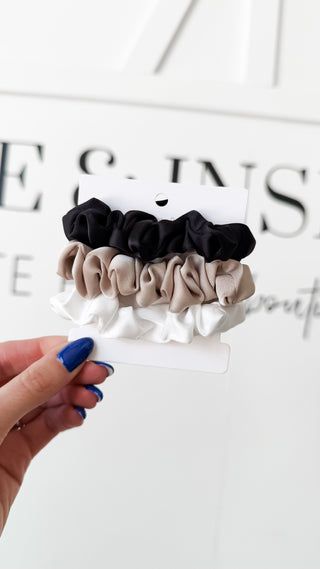 Set of black, beige, and white scrunchies 