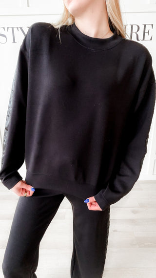 black crewneck with satin stripe down the arms