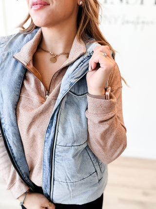 light blue denim puffer vest with zipper and pockets