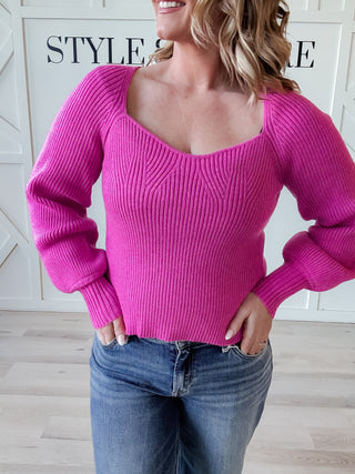 pink sweater with balloon sleeves and sweetheart neckline