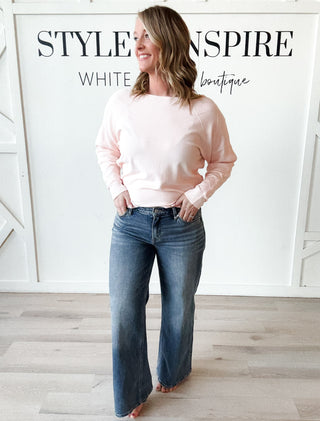 pink crewneck sweater with pattern sleeve