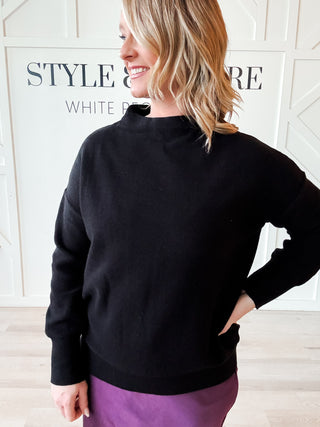 black funnel neck sweater