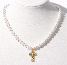 Pearl necklace with a gold cross pendant on a white background