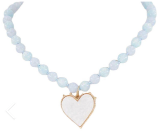Necklace with light blue beads and a white heart pendant on a white background