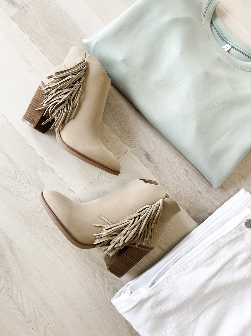Fringe trim adds dimension to a block-heel bootie that's a modern take on Western style. Natural/tan color. 4 inch heal