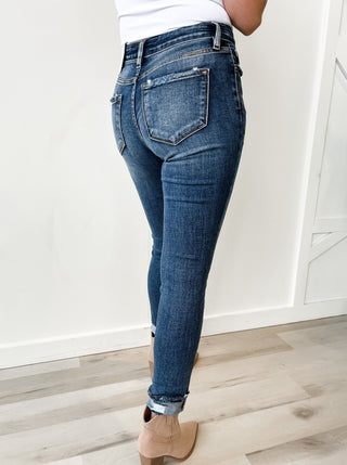 High rise skinny jean. Medium stone wash. Distressed ankles. 