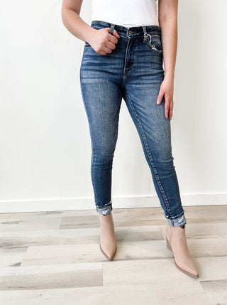 High rise jean. Medium stone wash. Distressed ankles. 